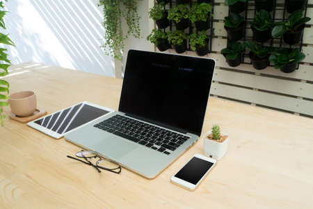 Office wood table and chair in the garden, natural work place at home.の写真素材