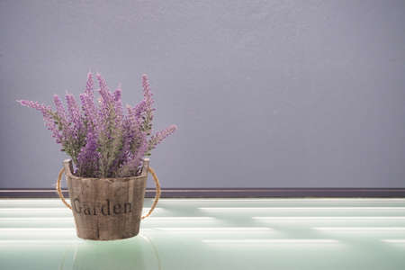 Glasses table with violet lavender flower on pot at day time.の写真素材