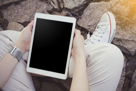 human hand holding blank screen tablet, cell phone.の写真素材