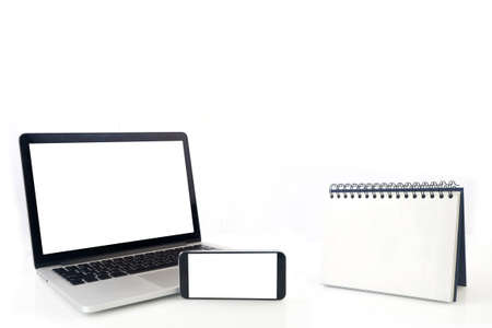 Desktop Loop wire binding book and blank screen of notebook ,cell phone, tablet, smartphone on isolated white background. concept of business connection.の写真素材