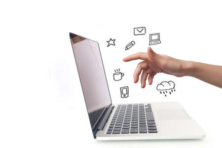 human hand touching on laptop screen with social media icons. concept of shopping online. side of laptop on isolated white background.の写真素材