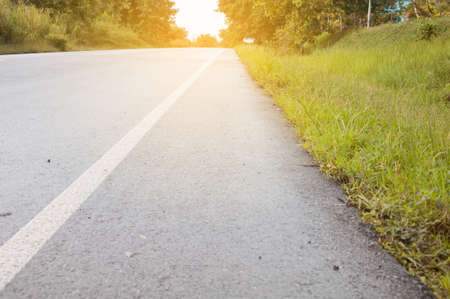 golden sunshine in the morning at side road with tree.の写真素材