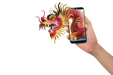 human hand hold smartphone, tablet, cell phone with big dragon statue come out screen. concept of celebrate Chinese New Year background with , concept of the Year of the Dragon.の写真素材