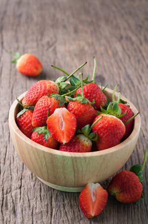 kitchen table with  strawberry on wood plate, healthy eating and dieting food, concept of health care,  Image focus top view.の写真素材