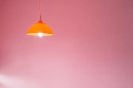 modern ceiling lights with pink cement wall background.の写真素材