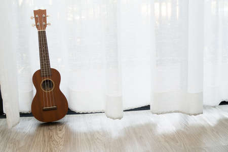 ukulele on white drape background texture.の写真素材