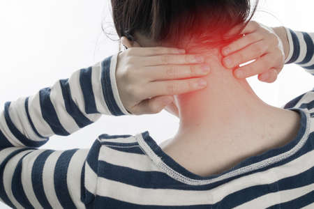 young woman having neck pain on isolated white background, concept of office syndrome. view from back body.の写真素材