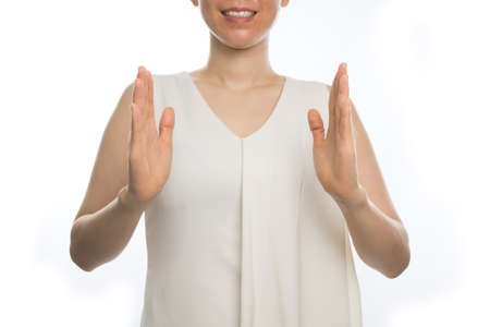 young asian woman holds hand virtual display screen on isolated white background.の写真素材