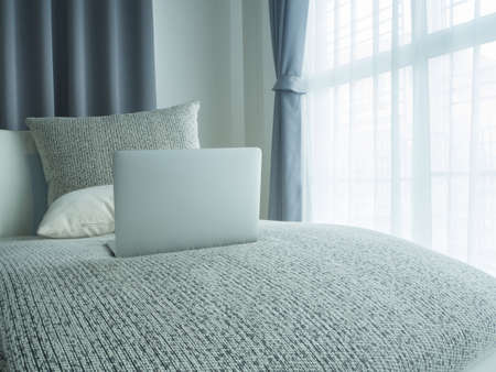 empty living room with back screen laptop and beautiful white drape window texture background in morning. concept of business lifestyle.の写真素材