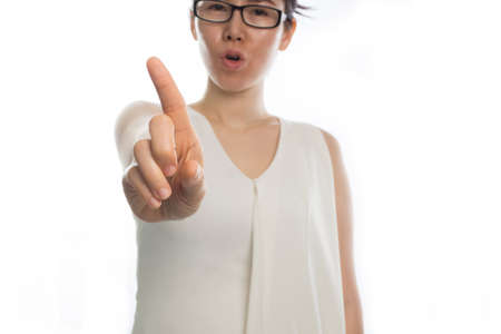 young asian woman pointing finger and say no on isolated white background.の写真素材