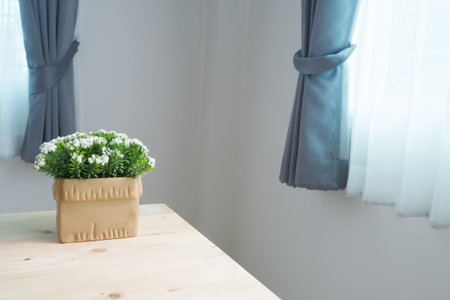 wood table with white flower on pot.の写真素材