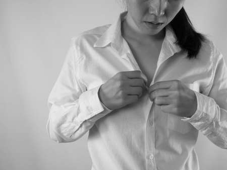 young asian woman Remove button white shirt on isolated background. Sad woman, black and white picture style.の写真素材