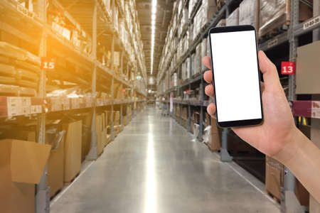 human hand holding blank screen smart phone, tablet, cellphone with blurry shelf store background. concept on shopping online.の写真素材