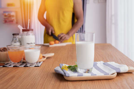 glass of milk with human preparing food for healthy and breakfast table. concept of health care lifestyle. top table.の写真素材