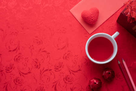 Valentine's day holiday celebration with hearts and cup of juice on red background, top view.の写真素材