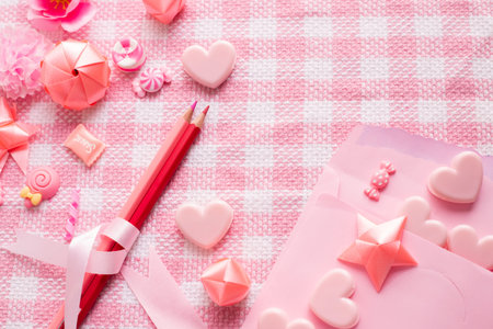 letter love and Valentine's Day Decoration on pink tablecloth texture background, top view.