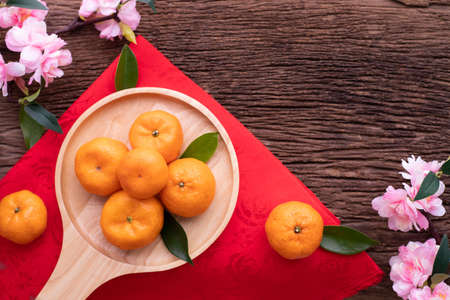Orange fruit and cherry blossom on wood table, Chinese new year celebration background, top view.の写真素材