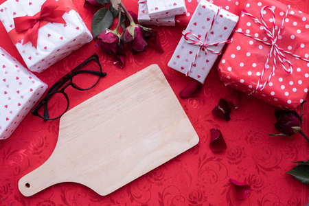 Blank surface Cutting Board with Valentine's day gift box, Valentine's Day celebration background, top view.の写真素材