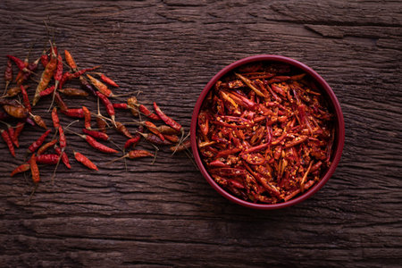 Kitchen table with dried chilli pepper, top view.の写真素材