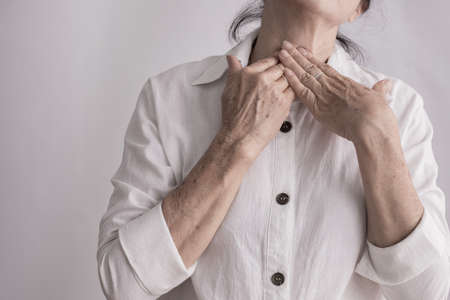 elderly having sore throat, concept of health care.の写真素材