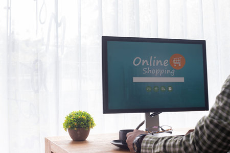 office desk with businessman using virtual online shopping website on computer screen, concept of...