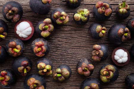 fresh mangosteen fruit with frame on wood table, copy space.の写真素材