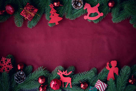 Copy space on Red fabric texture and Christmas frame background with decorations, view from above.の写真素材