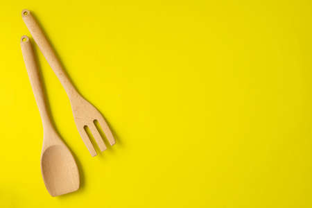 Copy space ofr text on yellow background and wooden kitchenware.の写真素材
