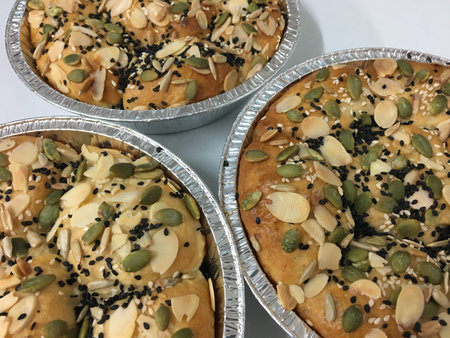 3 sesame and black seed buns topped with sunflower seed
