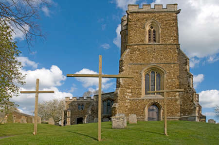 An English Parish Church with 3 crosses outside at Easter timeの写真素材