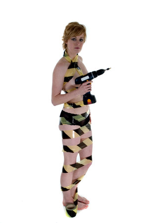 An attractive blonde woman standing with electric drillの写真素材