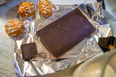 A bar of chocolate is combined with pastries and milk