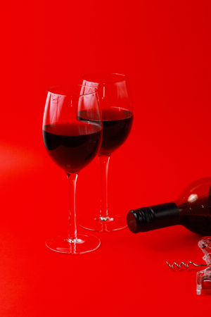 wine in glasses with wine bottle and corkscrewの写真素材