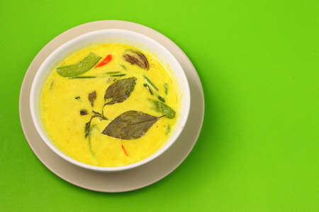 Hot and spicy chicken green curry on a green backgroundの写真素材