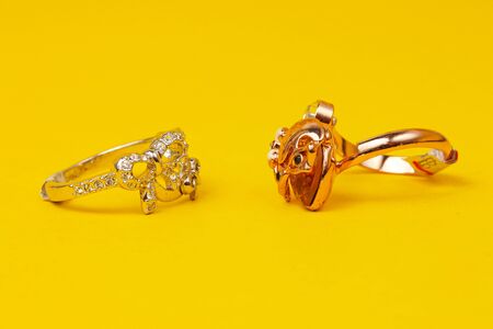 Ornamental unusual rings set in a yellow backgroundの写真素材