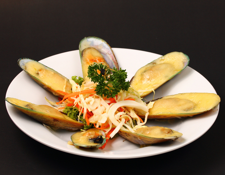 new Zealand mussels in cheese sauce with a black backgroundの写真素材