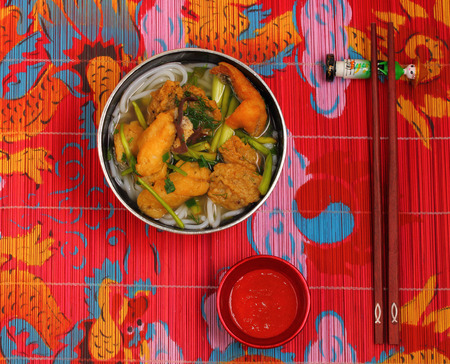 Vietnamese chicken noodle soup on a place matの写真素材