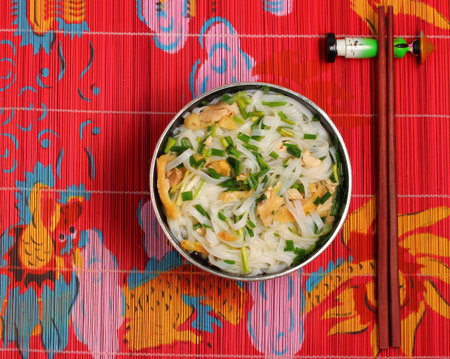 Hanoi pho chicken noodle soup on a bamboo place mat