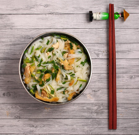 Hanoi pho chicken noodle soup on a wooden table