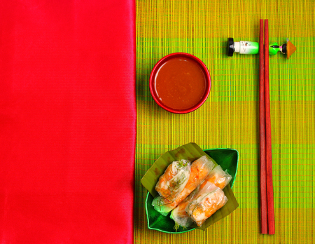 Vietnamese wafer thin spring rolls on a place mat with a silk napkinの写真素材
