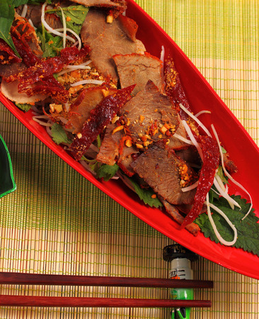 beef salad vietnamese style served on a bamboo place matの写真素材