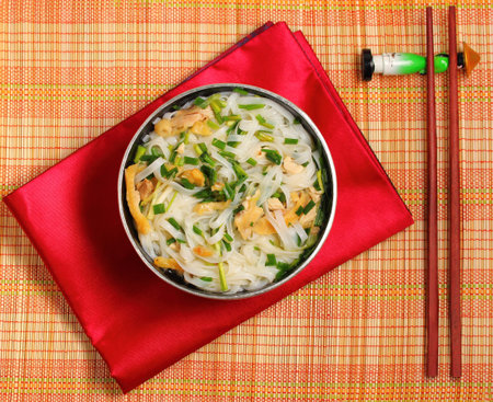 Hanoi pho chicken noodle soup on a bamboo place mat
