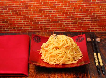 spaghetti  carbonara served on a wooden table topの写真素材