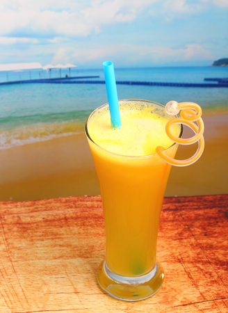 pineapple juice in glass on wood table top on an islandの写真素材