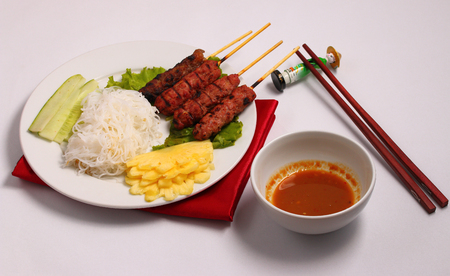 Vietnam beef on sticks served with salad with a white backgroundの写真素材