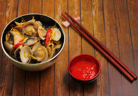 herbal clam soup Vietnam style served on a wood table topの写真素材