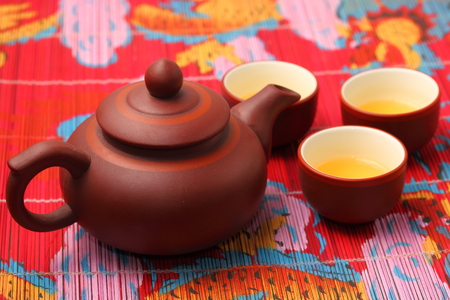 Asian tea set served on a bamboo place matの写真素材