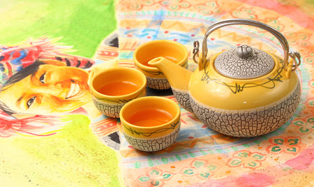 Asian style tea set on a Vietnamese table clothの写真素材