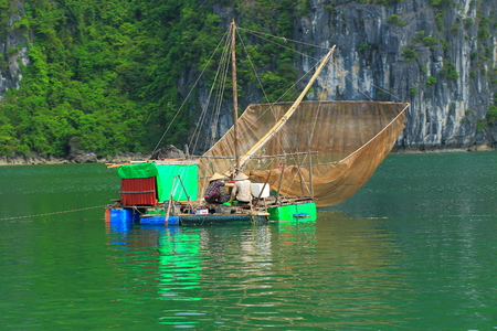 traditional vietnam fishing boat with netの写真素材