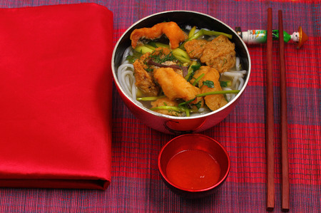 Vietnamese chicken noodle soup on a place matの写真素材